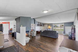 Living area with wainscoting, wood finished floors, and a multi sided fireplace