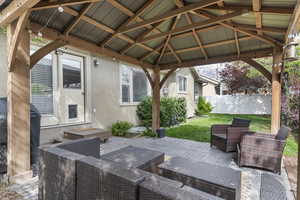 View of patio / terrace with a gazebo, fence, and an outdoor living space