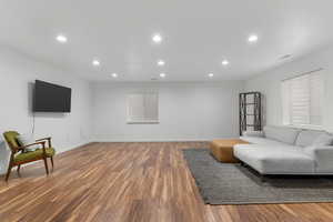Large basement living area with full sized windows.