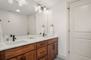 Full bath  featuring large  vanity, and tiled shower
