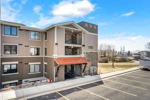 Lake Residences Building E view of building exterior with uncovered parking