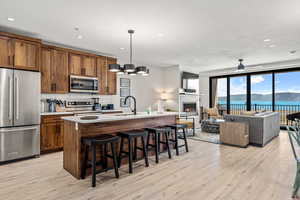 Great room with lake view, and appliances with stainless steel finishes
