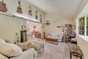Living room with vaulted ceiling and carpet flooring