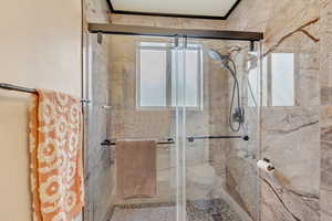 Full bathroom with a shower stall