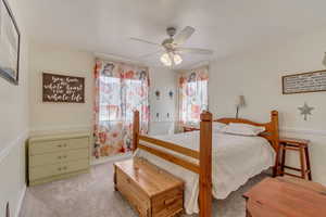 Carpeted bedroom with ceiling fan