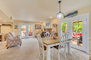 Dining space with light carpet, french doors, and recessed lighting
