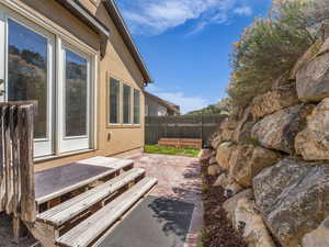 View of property exterior with a fenced backyard, a patio, and stucco siding