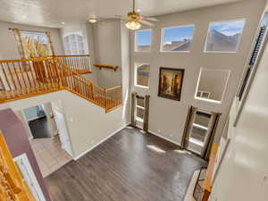 Entryway with wood finished floors, ceiling fan, baseboards, visible vents, and recessed lighting