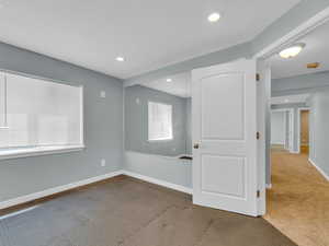 Spare room with recessed lighting, carpet, and baseboards