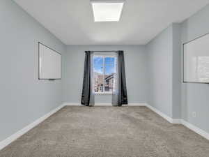 Carpeted empty room with baseboards
