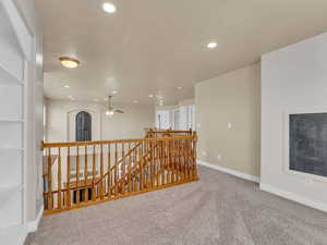 Corridor featuring baseboards, carpet flooring, recessed lighting, and an upstairs landing