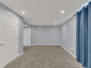 Below grade area featuring recessed lighting, baseboards, and carpet