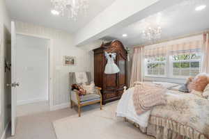 Bedroom with a chandelier, baseboards, recessed lighting, and light colored carpet