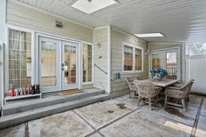 View of patio with outdoor dining area and french doors