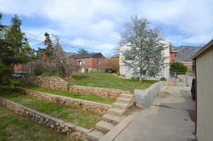 View from back yard fence - featuring a large terraced entertainment style yard