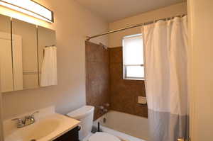 Full bathroom with shower / tub combo, toilet, and vanity