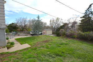 View from side of the home to the backyard - New storage shed to stay with property.