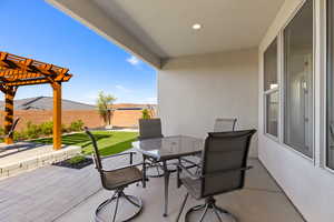 View of patio featuring a pergola, outdoor dining area, and fence