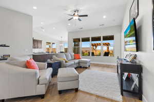 Living room featuring recessed lighting, lofted ceiling, light wood-type flooring, and a ceiling fan