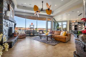 Living room featuring hardwood / wood-style flooring, recessed lighting, visible vents, and a fireplace