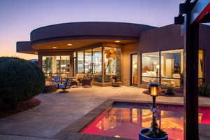 Back of house featuring an outdoor pool and a patio