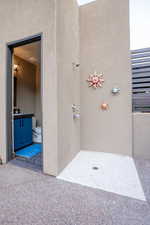 Doorway to property featuring stucco siding