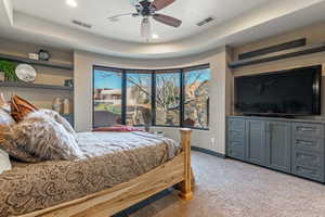 Bedroom featuring a tray ceiling, light colored carpet, baseboards, visible vents, and recessed lighting