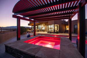 Outdoor pool featuring a patio and an in ground hot tub