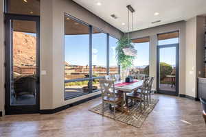 Dining space featuring hardwood / wood-style floors, baseboards, visible vents, and recessed lighting