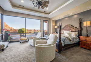 Bedroom with ceiling fan, recessed lighting, visible vents, and a raised ceiling