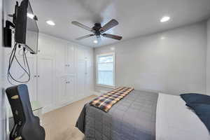 Bedroom featuring light carpet, recessed lighting, and ceiling fan