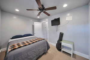 Bedroom featuring recessed lighting, light carpet, baseboards, and ceiling fan