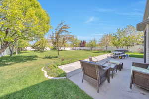 View of yard with a patio area, a fenced backyard, and an outdoor living space