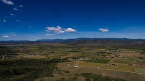 Birds eye view of property featuring a mountain view and a rural view