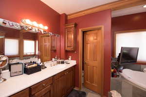 Bathroom featuring a bath, vanity, and tile patterned flooring