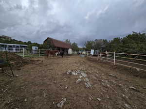 View of yard with a rural view, an exterior structure, and an outbuilding