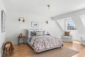Bedroom with light wood-type flooring and baseboards