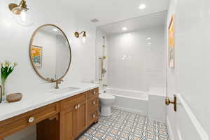 Bathroom featuring tile patterned floors, visible vents, toilet, vanity, and  shower combination