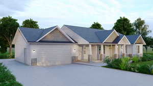 View of front of home with concrete driveway, stone siding, covered porch, a garage, and roof with shingles