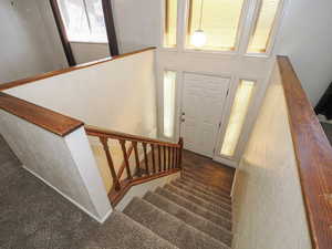 Foyer featuring stairway and a towering ceiling