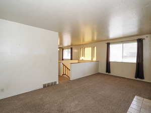 Unfurnished room with carpet and visible vents