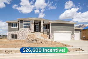 Prairie-style house featuring stone siding, an attached garage, and concrete driveway