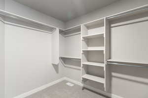 Walk in closet featuring carpet flooring