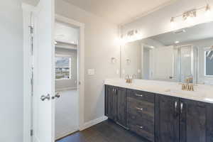 Full bath featuring a sink, a stall shower, double vanity, tile patterned flooring, and visible vents