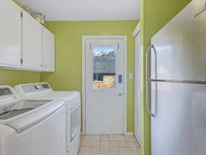 Washroom with light tile patterned flooring , and cabinet space