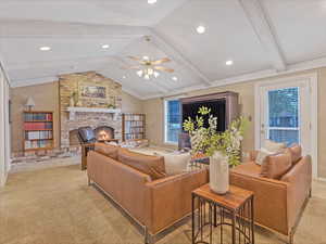 Family room with lofted ceiling with beams, ceiling fan, light colored carpet, a brick fireplace, and recessed lighting