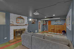 Living room featuring fireplace,  a bar, and recessed lighting