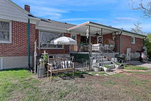 Back of property featuring brick siding