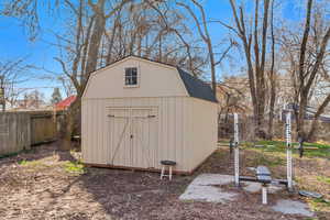 View of shed featuring fence