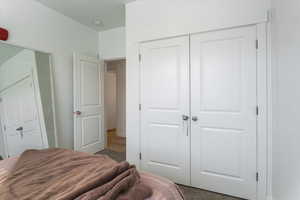 Bedroom featuring a closet and carpet flooring